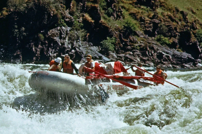 white water rafting on the middle fork of rapids with two men riding behind