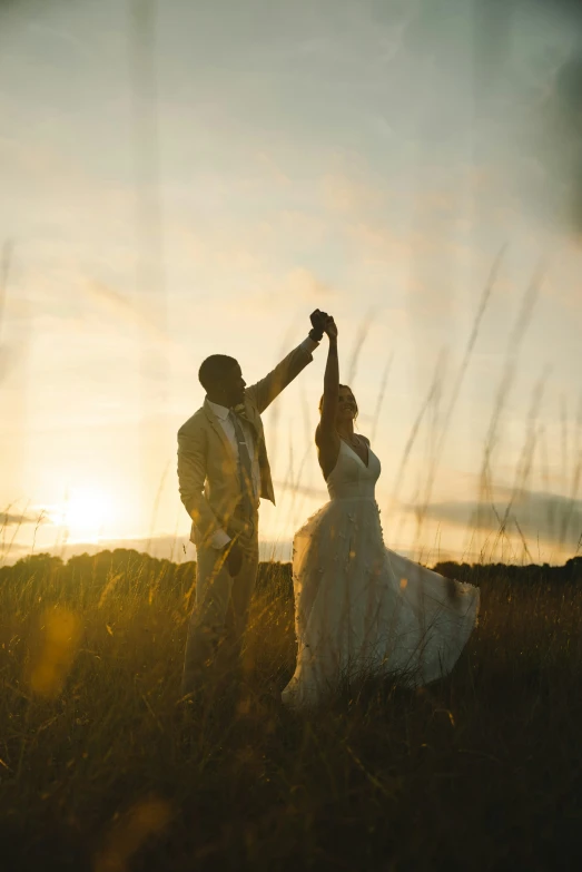 a man and woman dancing on top of a field