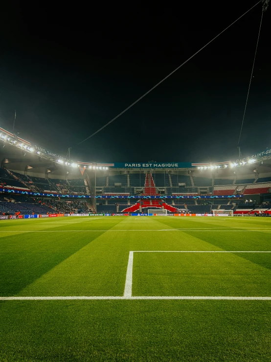 a large stadium with a field full of grass