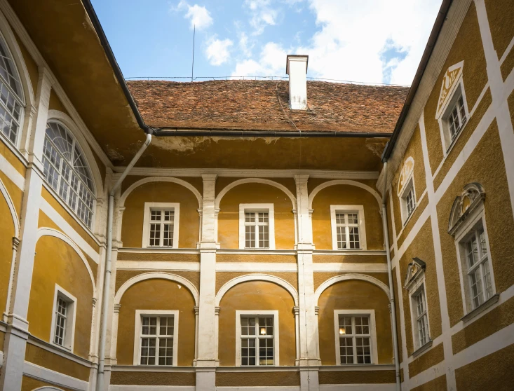 the interior courtyard of an old building under a blue sky