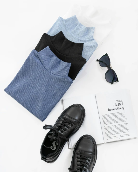 a pair of black and white shoes and some clothing and a book