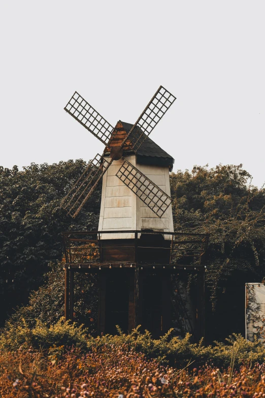 a rustic old farm house with two windmills