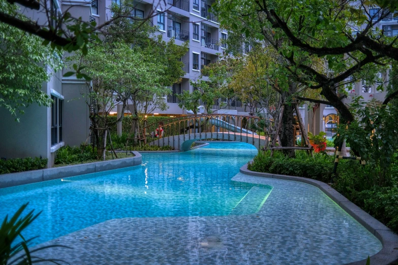 a long pool sits next to an apartment building