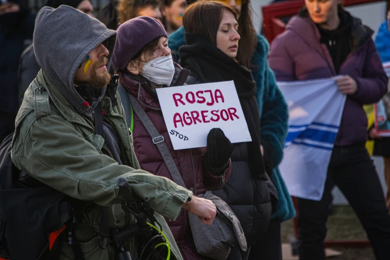 some people are protesting outside while others hold signs