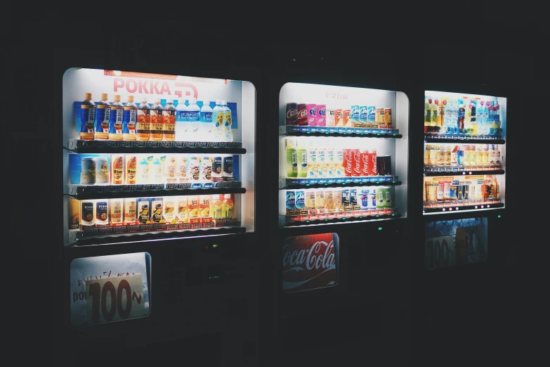 three rows of vending machines with soda, pepsi and pepsi