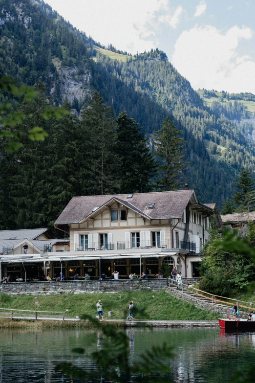 an old building with some people on boats in the water