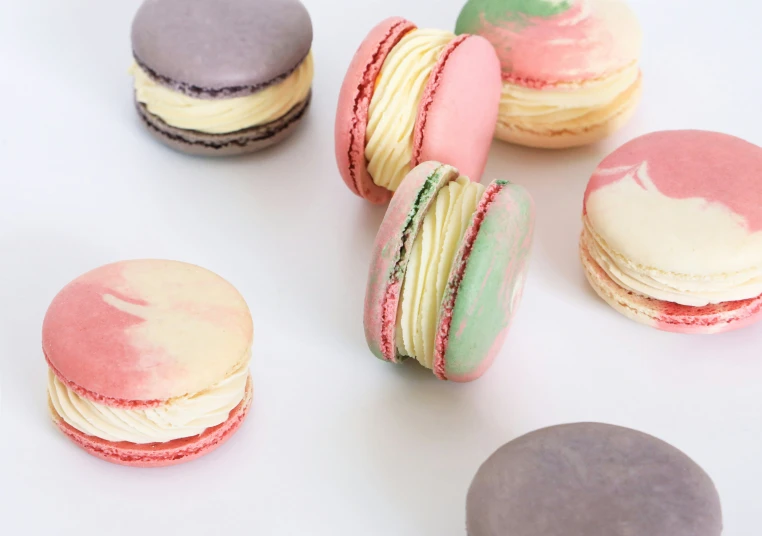 a group of different color macaroons on a table