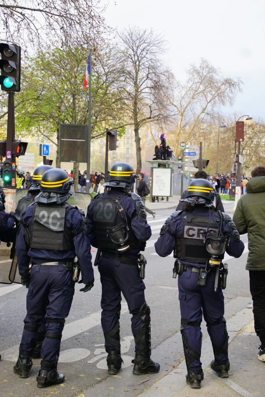 police officers standing in front of a cross walk