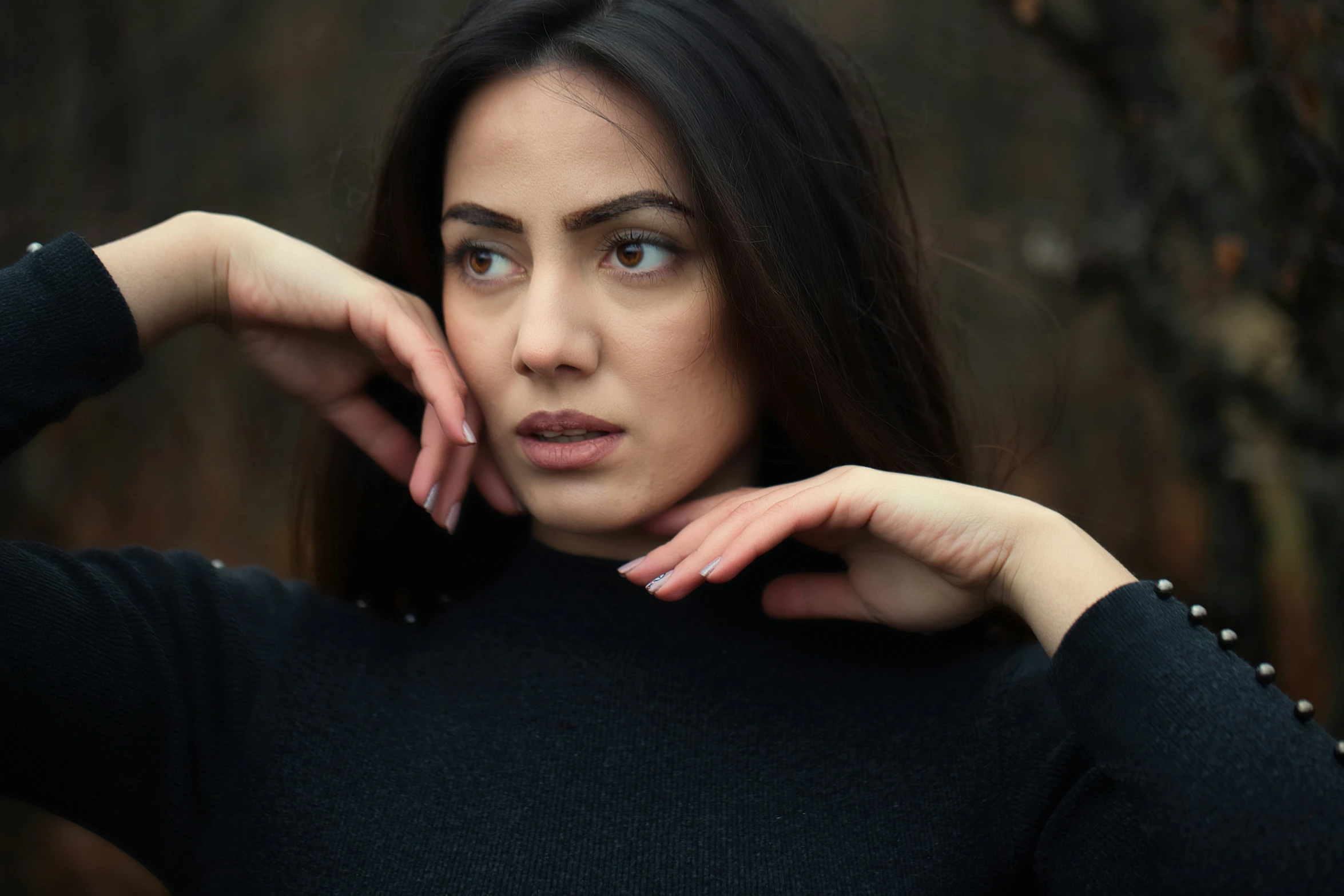 a woman leaning her head on her hand and looking straight ahead