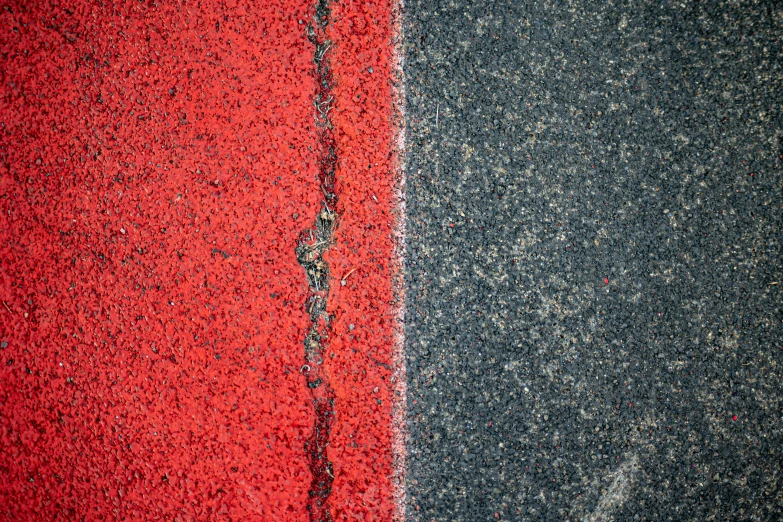 a sidewalk with paint and black lines next to it