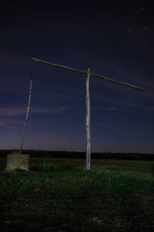 an pole, with stars in the sky and grass
