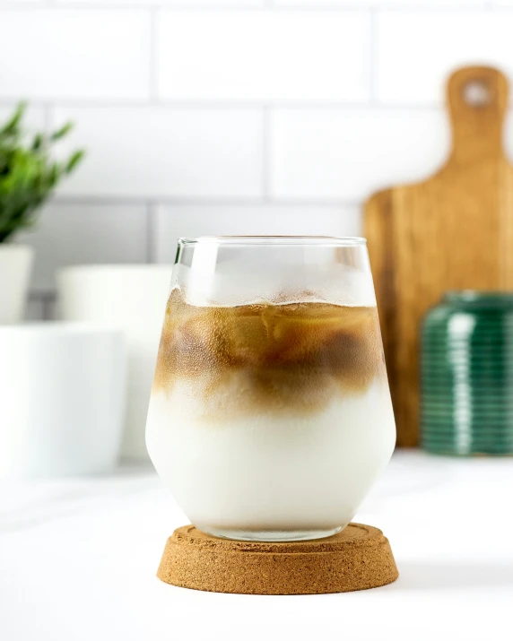 the pitcher of iced drink sits on a wooden stand