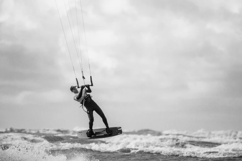 a man with a parasail in the ocean waves