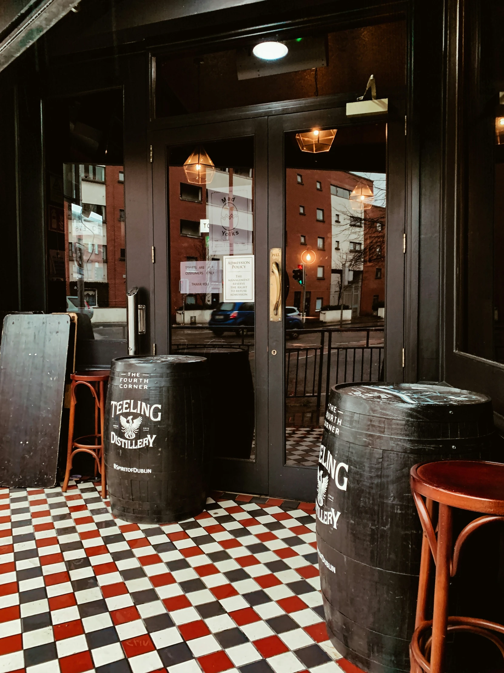 two black and white tiles in front of a restaurant