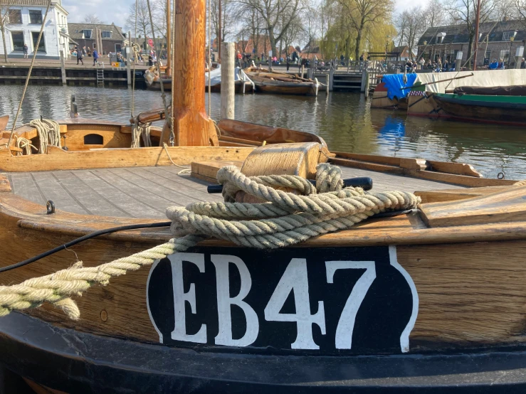 several boats sit on the water next to the shore