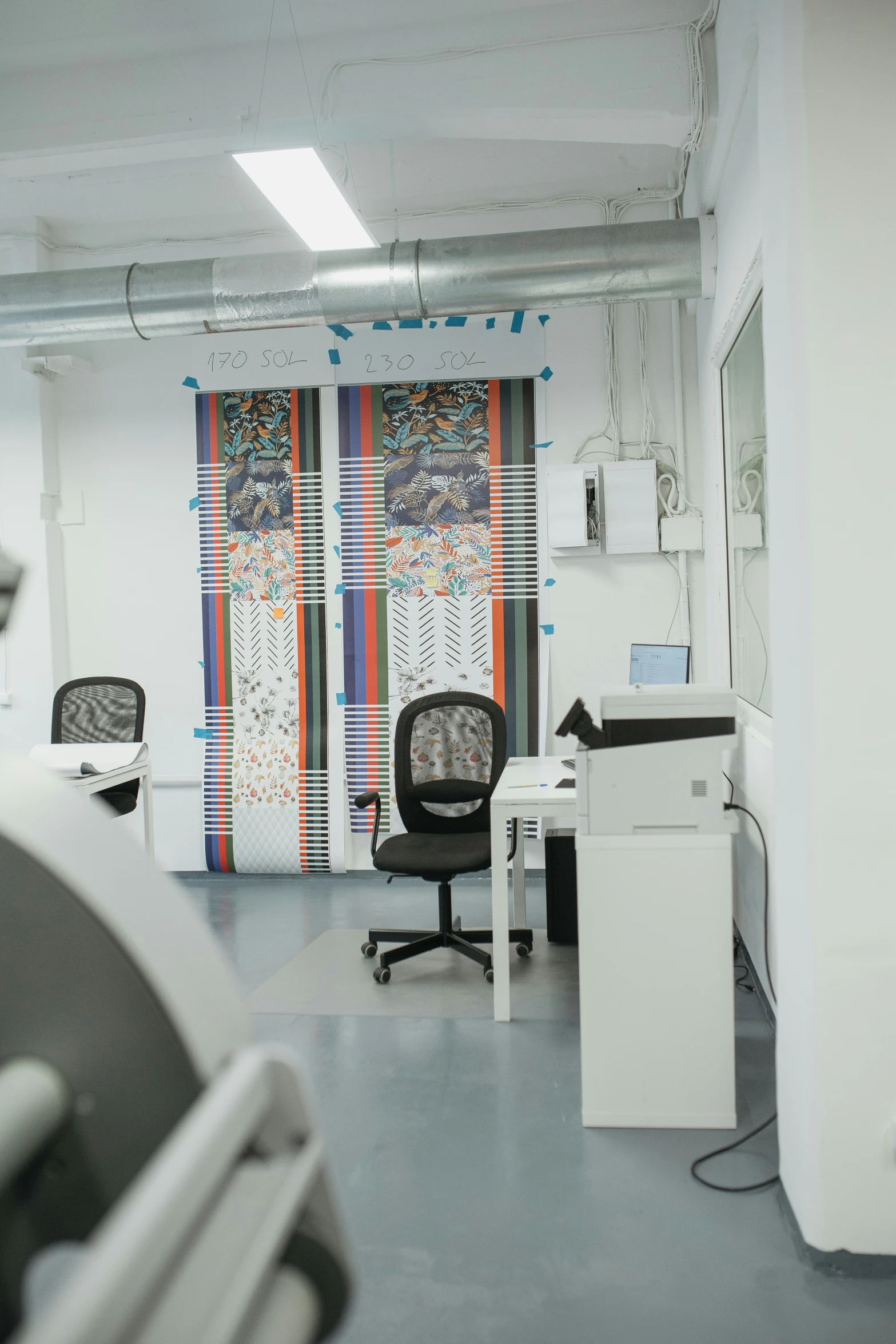 a work room filled with furniture and office supplies