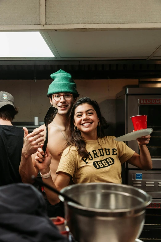 two people that are standing in the kitchen