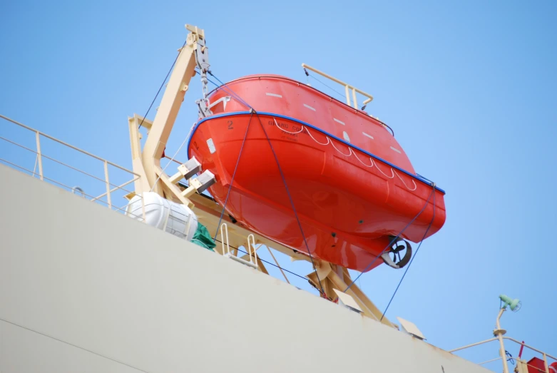 a red and blue boat on top of a white building