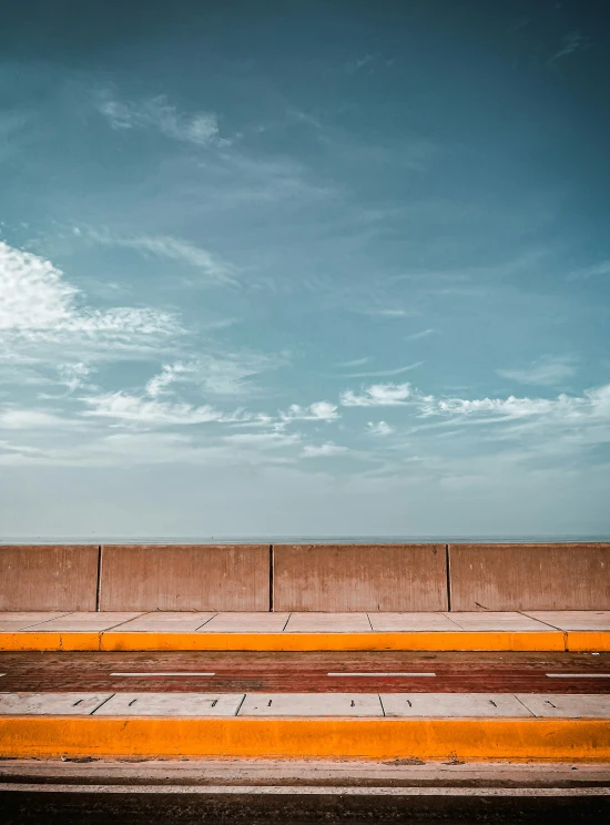 a man with a suitcase standing on top of a yellow curb