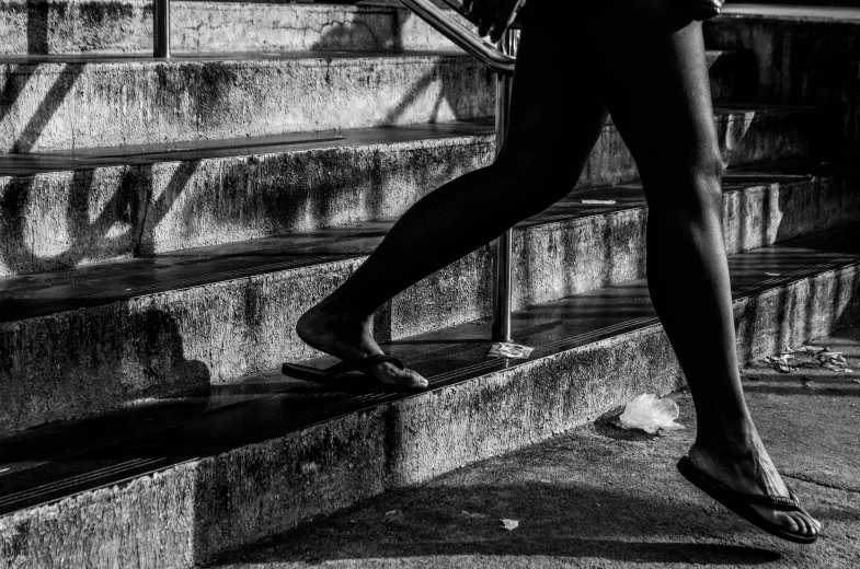 woman walking up some steps on her cell phone