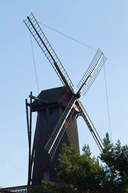 a windmill in a field with a fence