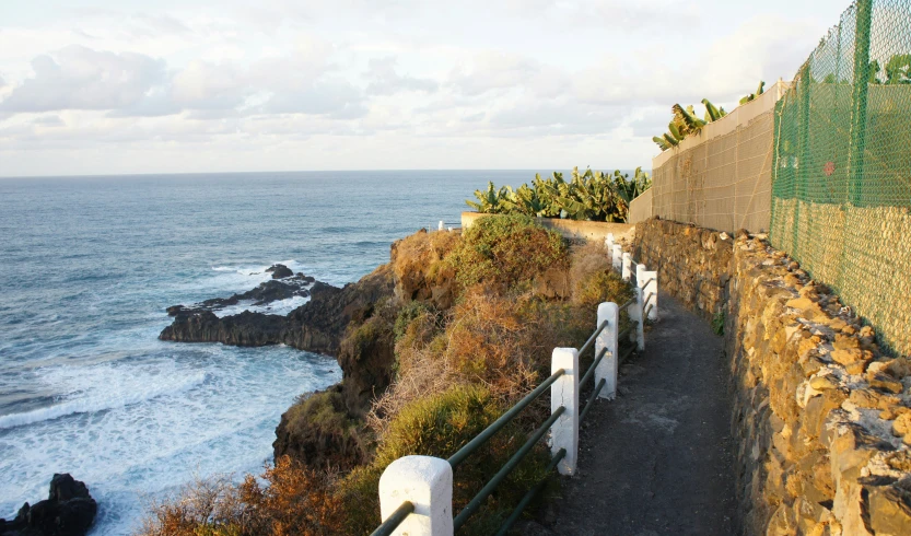 a couple of benches sitting on the side of a cliff