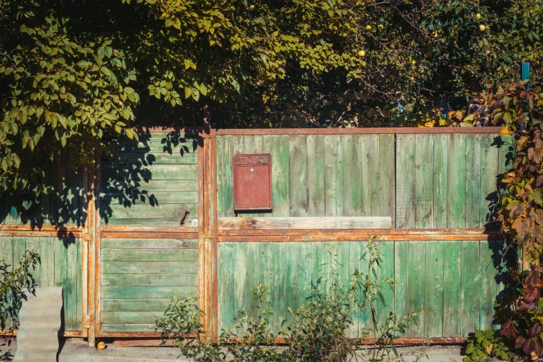 an image of old door on a green fence