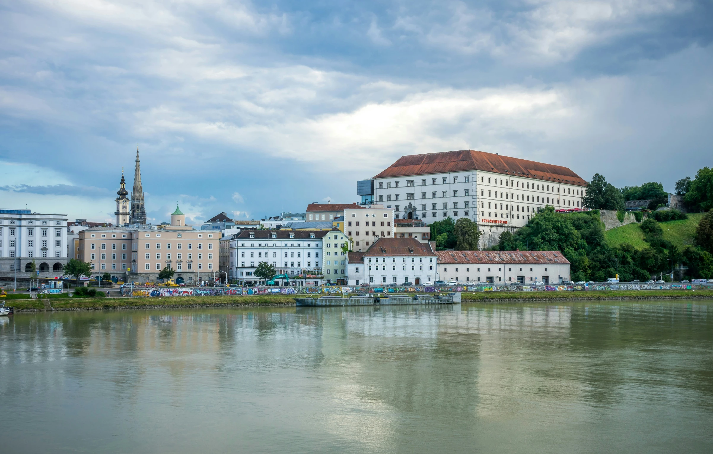 city sitting on a river with green water