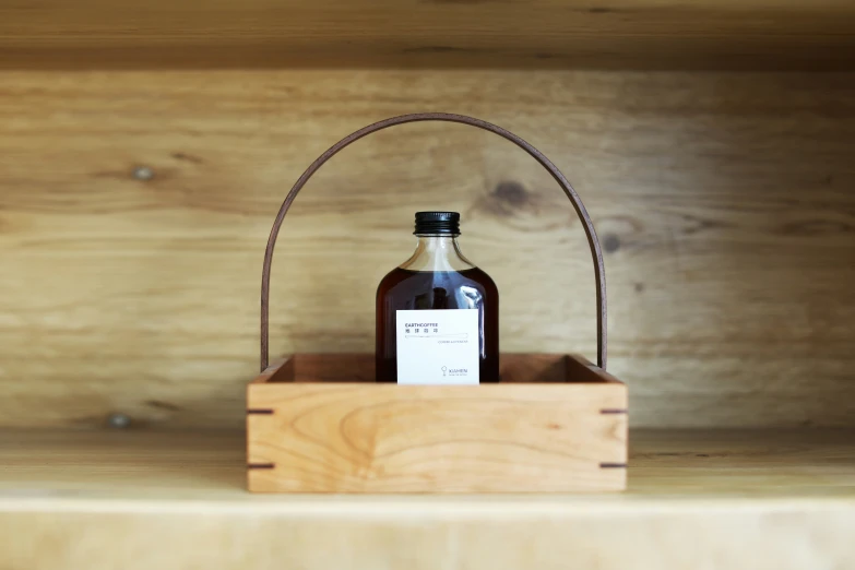 an empty bottle sitting inside of a wooden crate