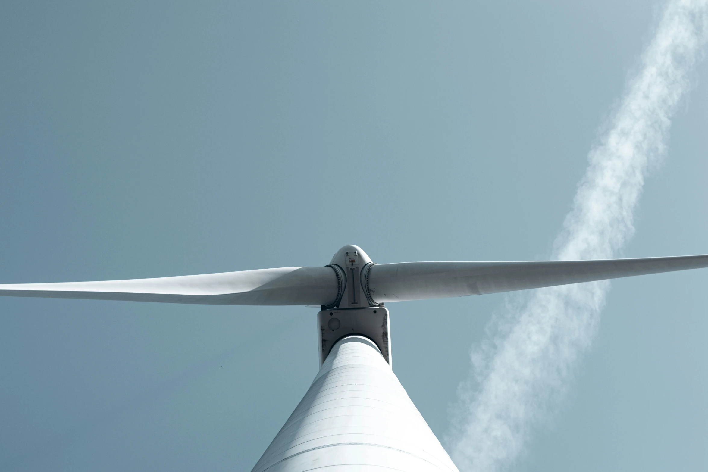 a wind turbine is shown with white smoke coming from the top