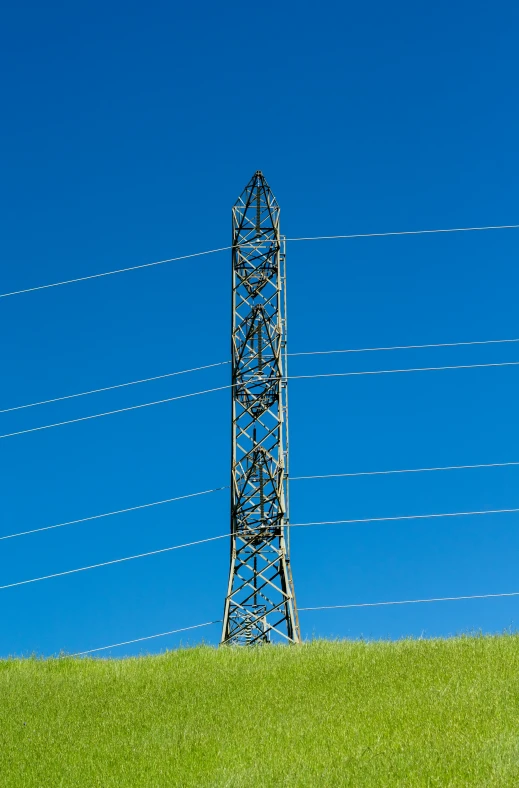 a blue sky with an electrical tower in the foreground