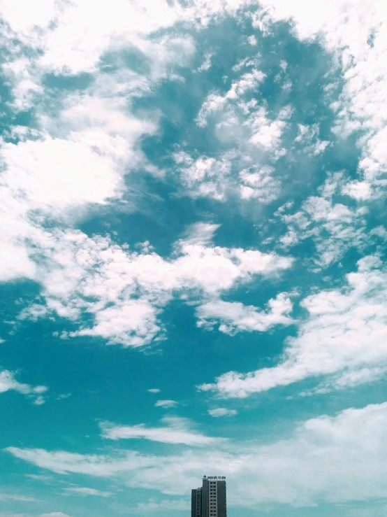 an airplane is flying in the blue sky