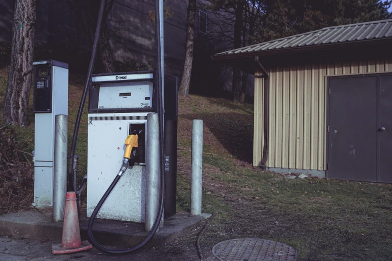 a dirty gas station has the pump open to collect water