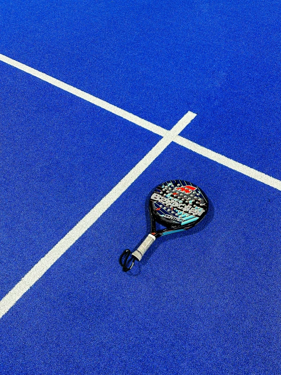 the tennis racket is on the blue court