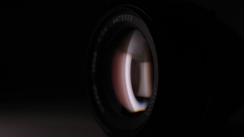 a camera lens in the dark with light