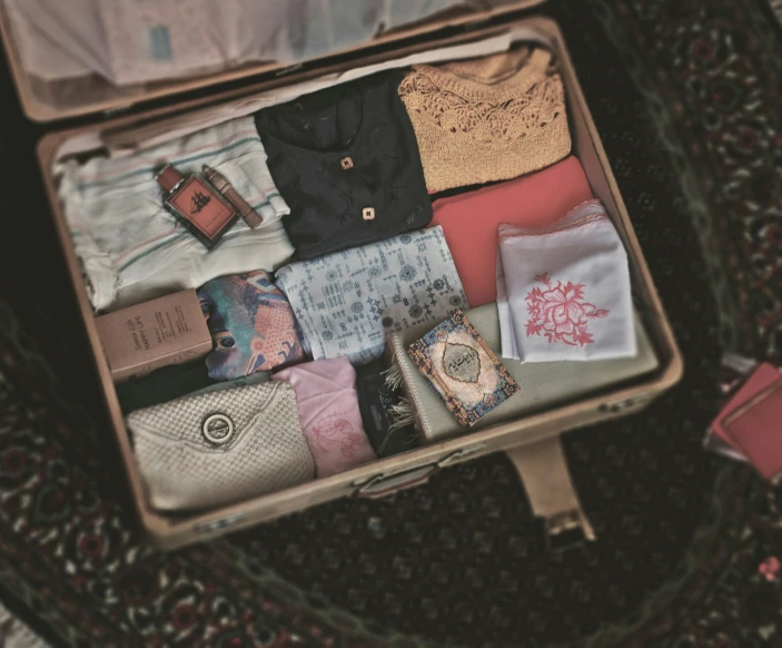 open open suitcase with clothes, shirts and other items