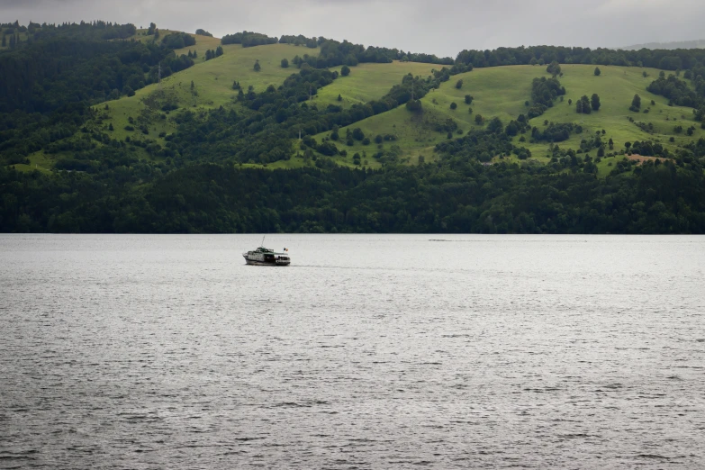 a boat floating across a body of water