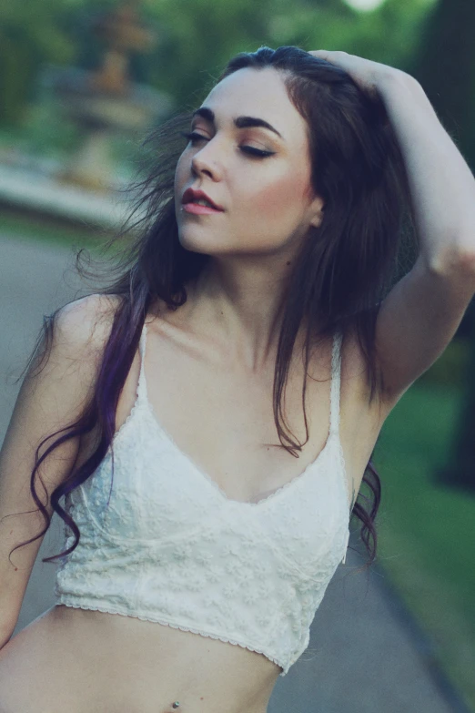 woman in white tank top holding her hair