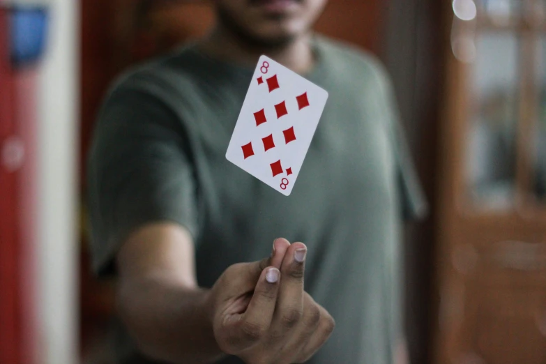 the person is holding up a card in his hand