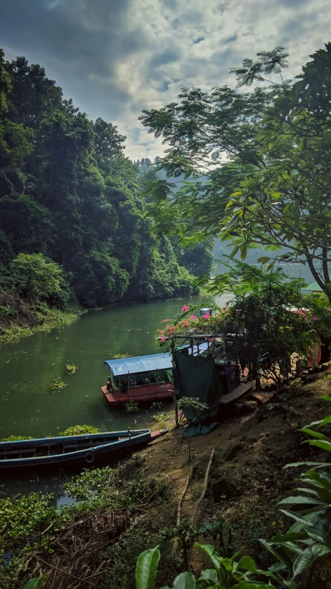 a boat sitting next to other boats on the river