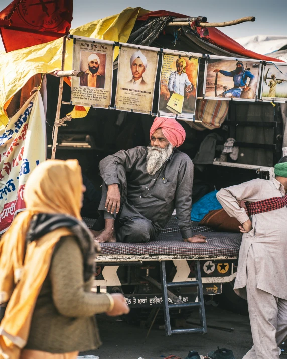 a man sitting on the back of a truck