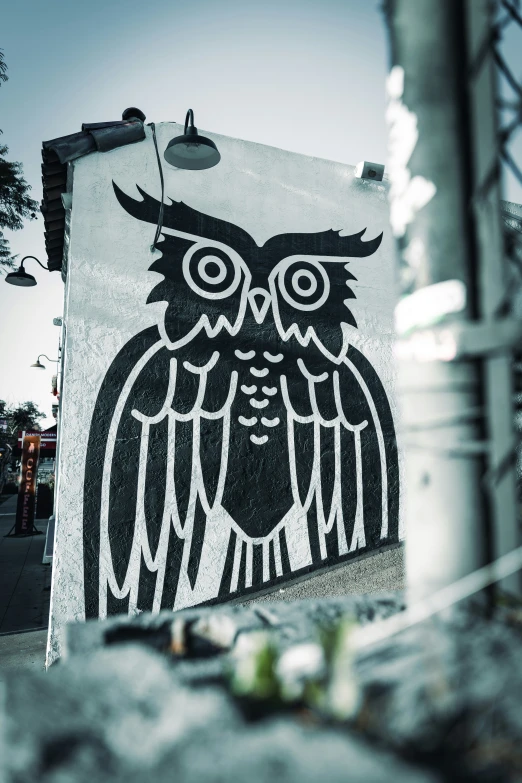 there is a large owl on this concrete sign