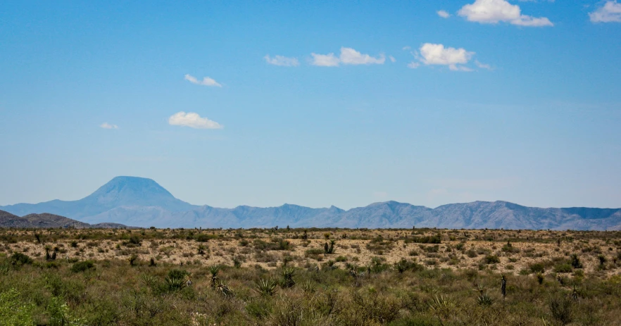 a plain with many mountains in the distance