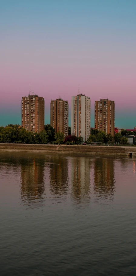 several apartments are seen on either side of the water