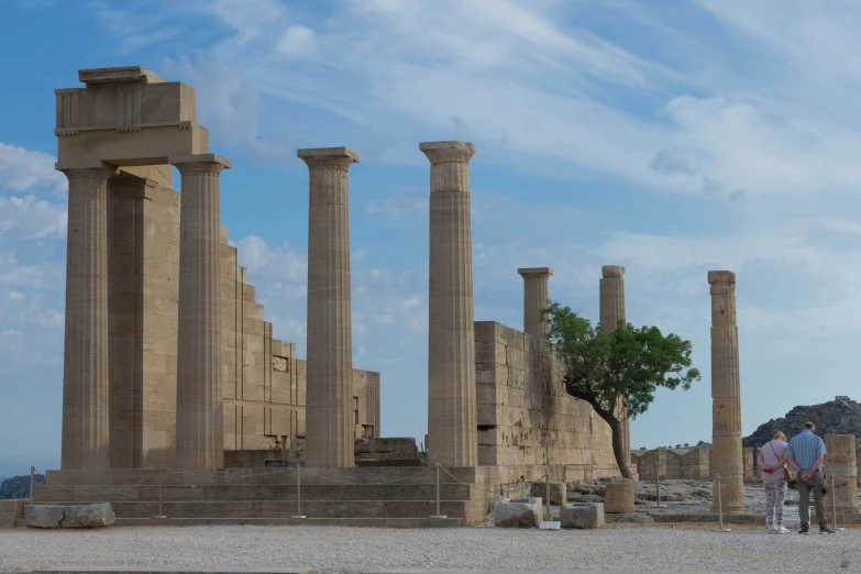 a couple walking through the ruins at a historical area