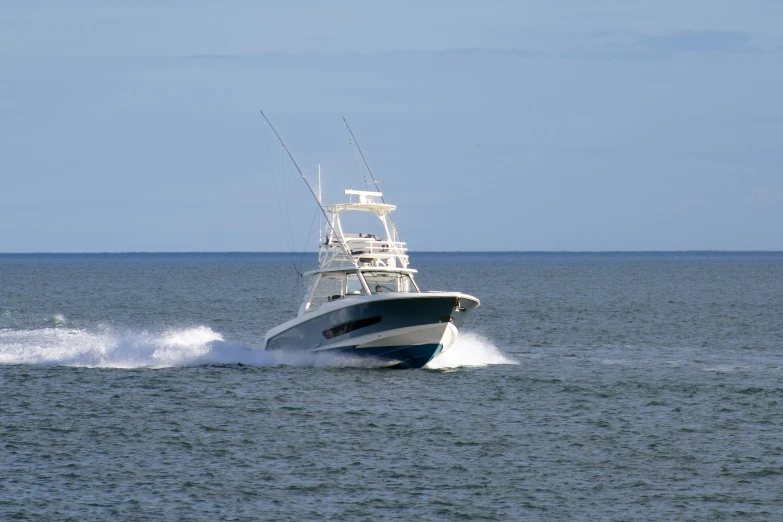 a large boat with three motorboats in the ocean