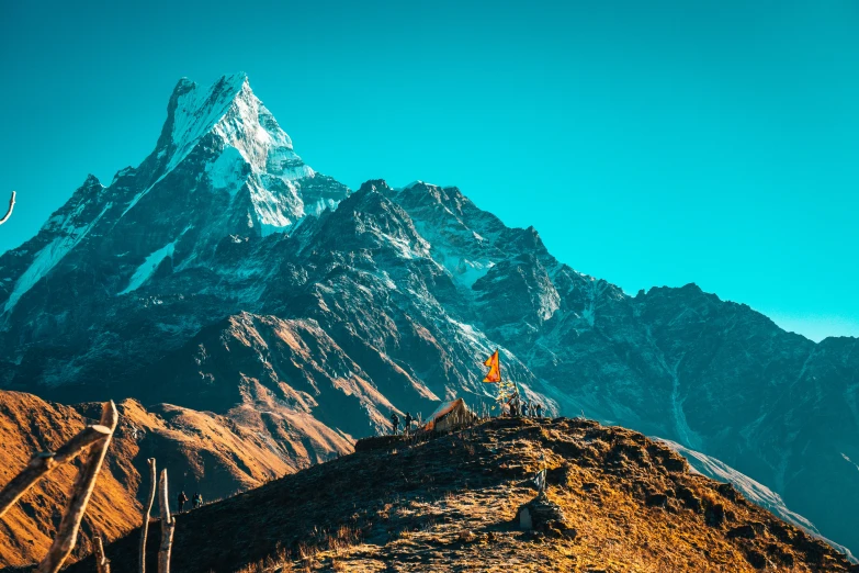 a hiker standing at the top of a tall mountain