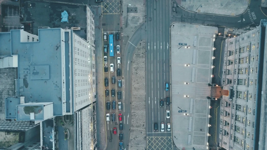a view of cars driving down the busy street from above