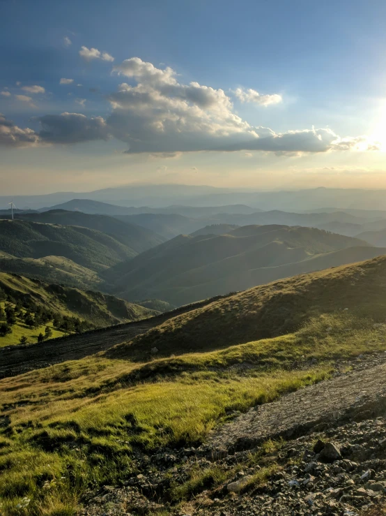 view of mountains from atop mountain at sunset