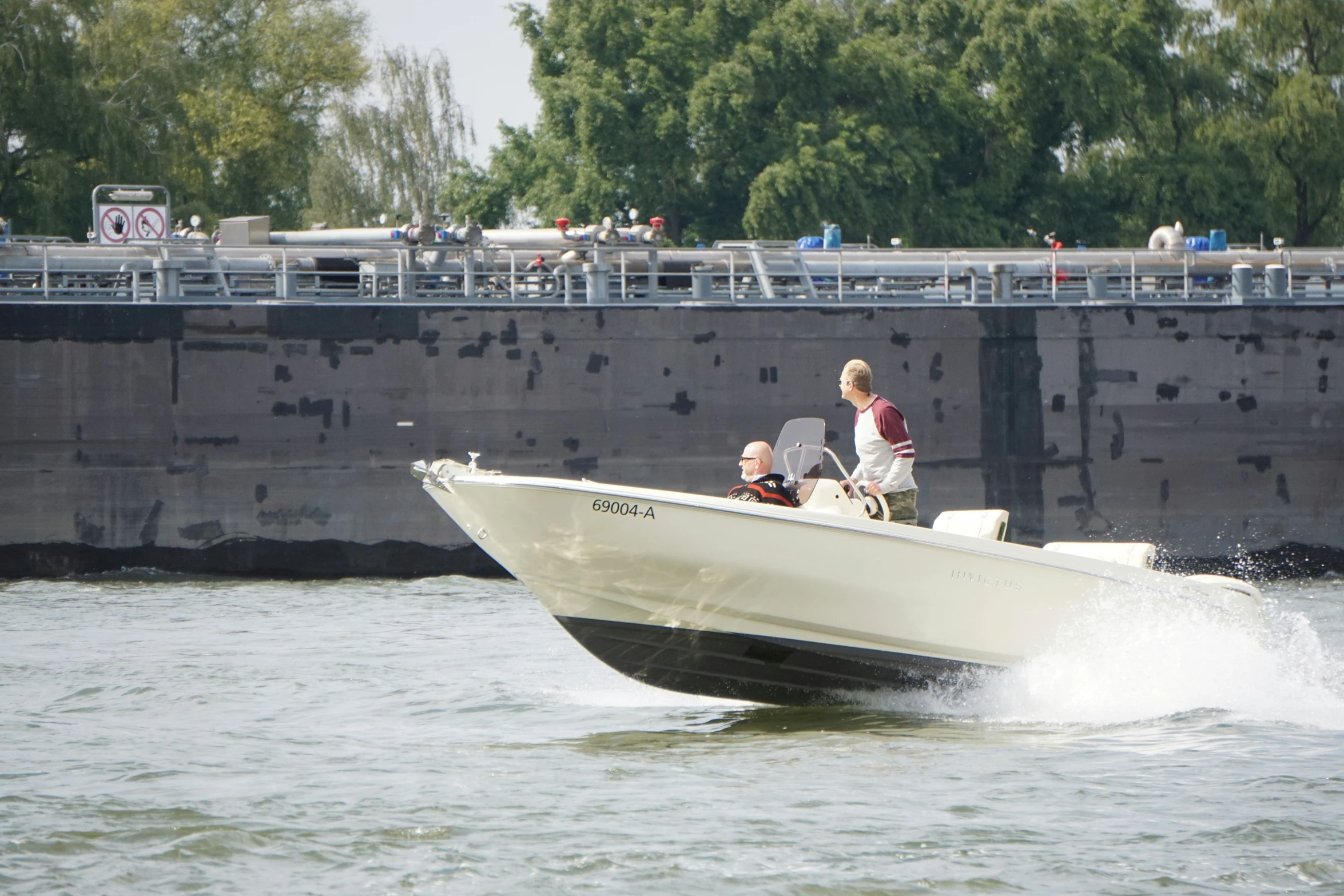 two men riding in the back of a boat